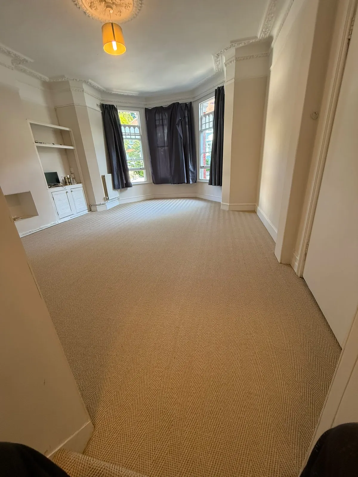 Herringbone sisal fitted in a bay-window living room