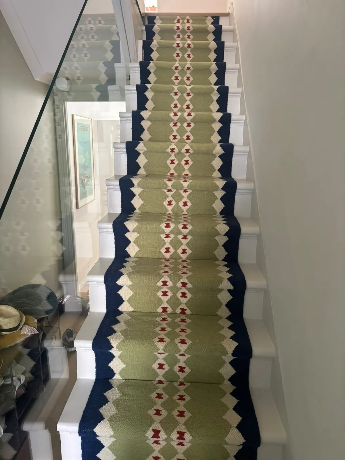 Green and navy flatweave stair runner on white stairs