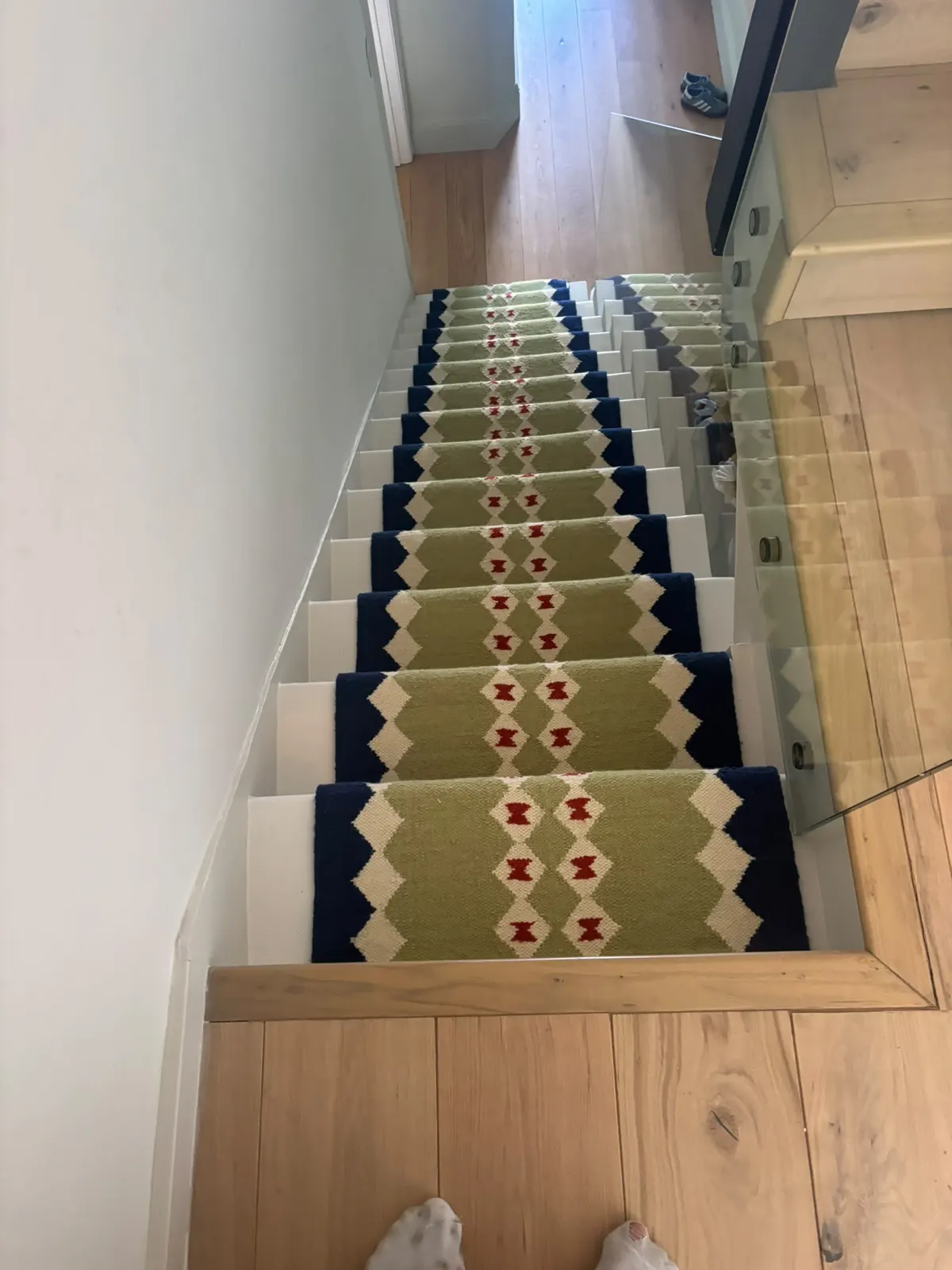 Green and navy flatweave stair runner seen from the top