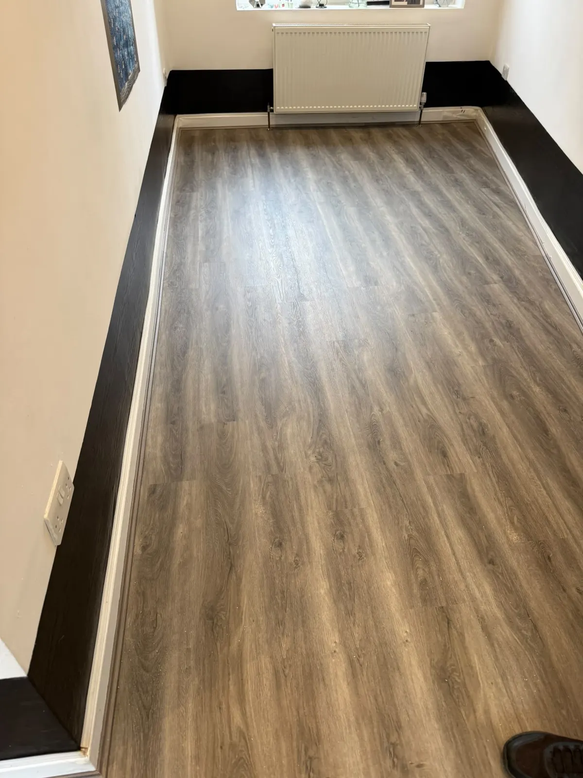 Oak-effect floor fitted in a long room