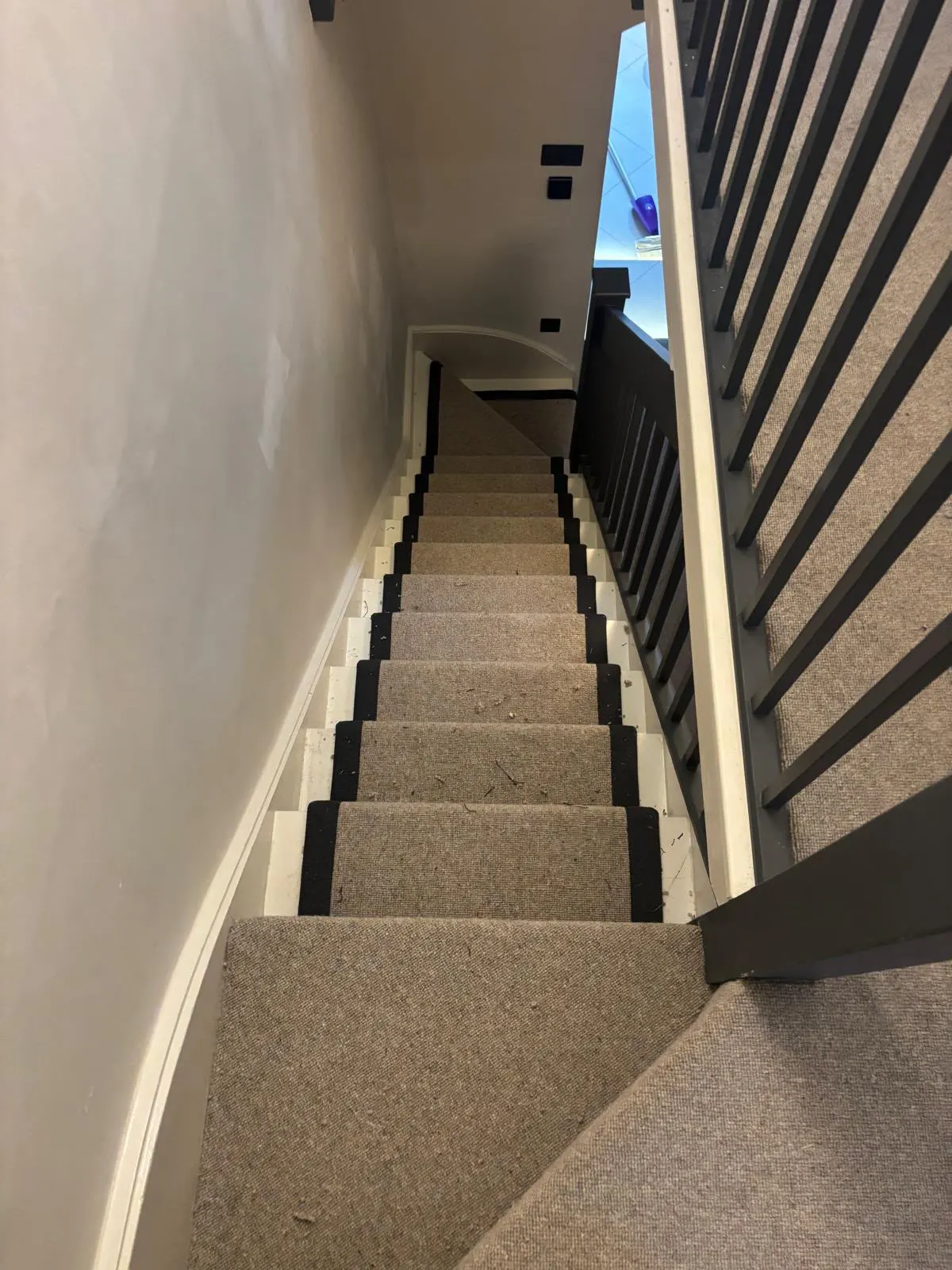 Beige stair runner with black bound edges