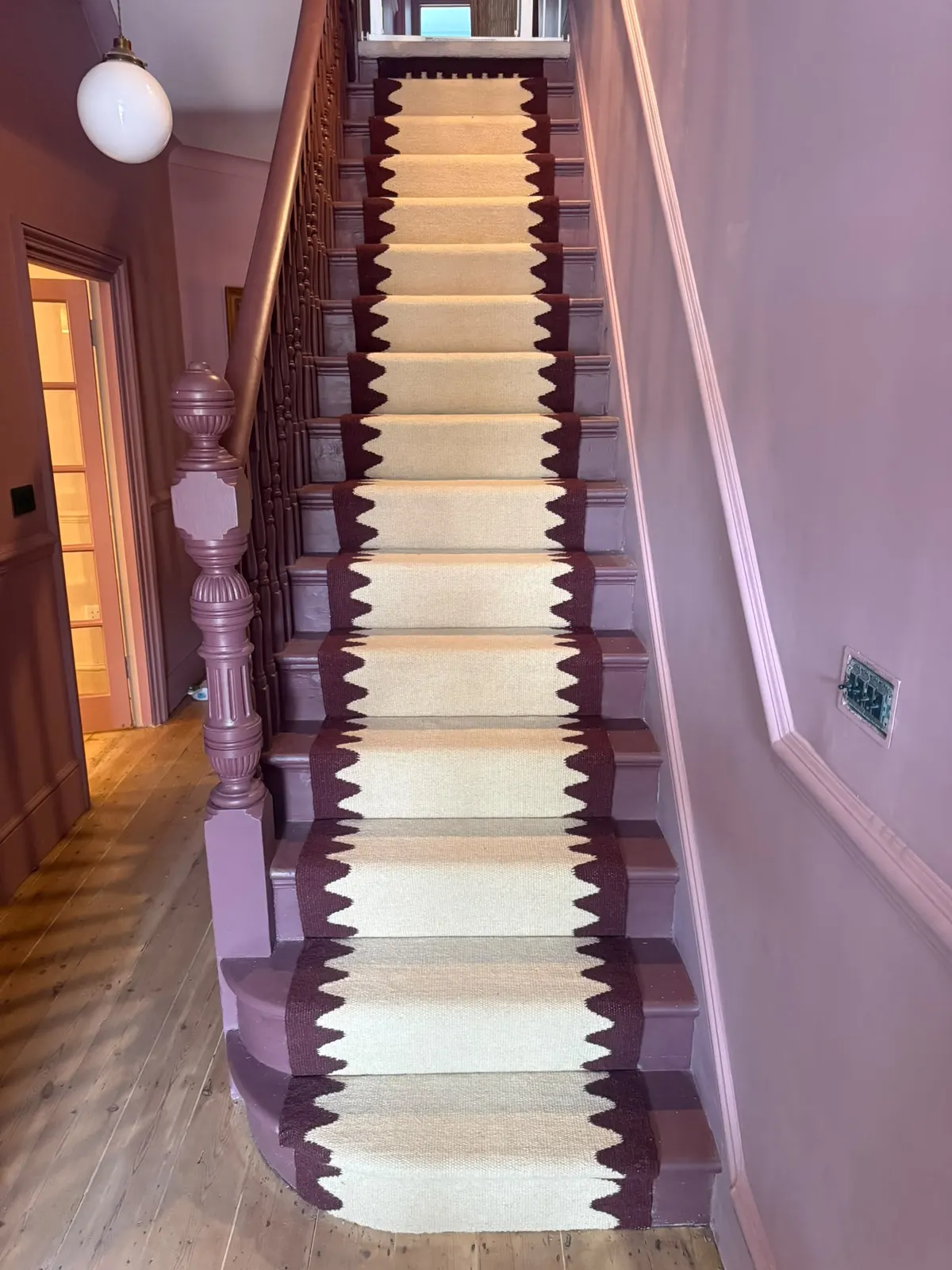 Cream stair runner with a burgundy zigzag border