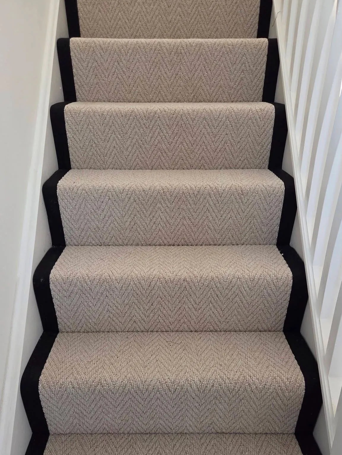 Herringbone stair runner with black bound edges