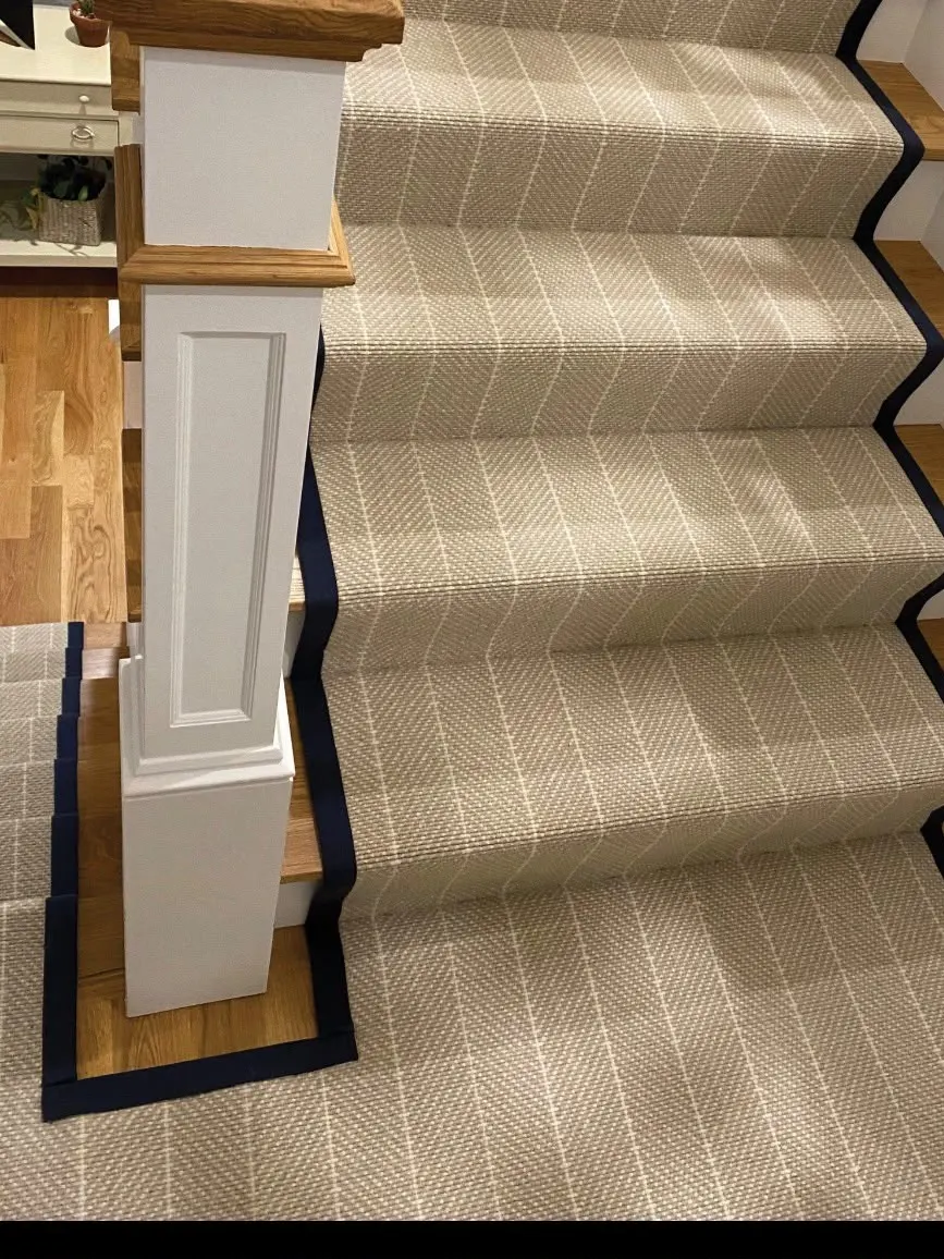 Pinstripe stair runner with navy border on oak stairs
