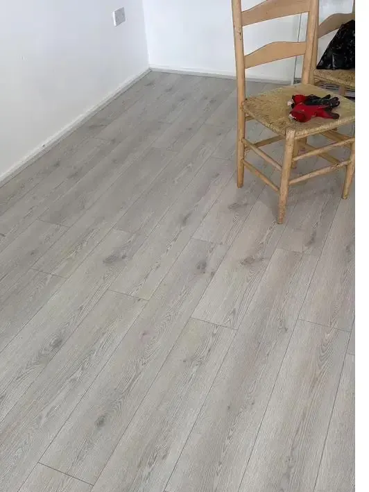 Light oak laminate flooring fitted in a bright living room