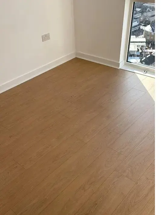 Warm oak laminate flooring in a sunlit room