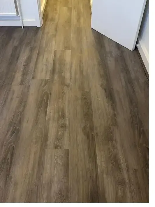 Taupe luxury vinyl tile flooring fitted in a hallway
