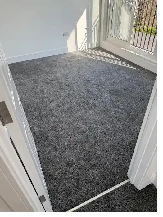 Dark grey carpet fitted on a bright landing