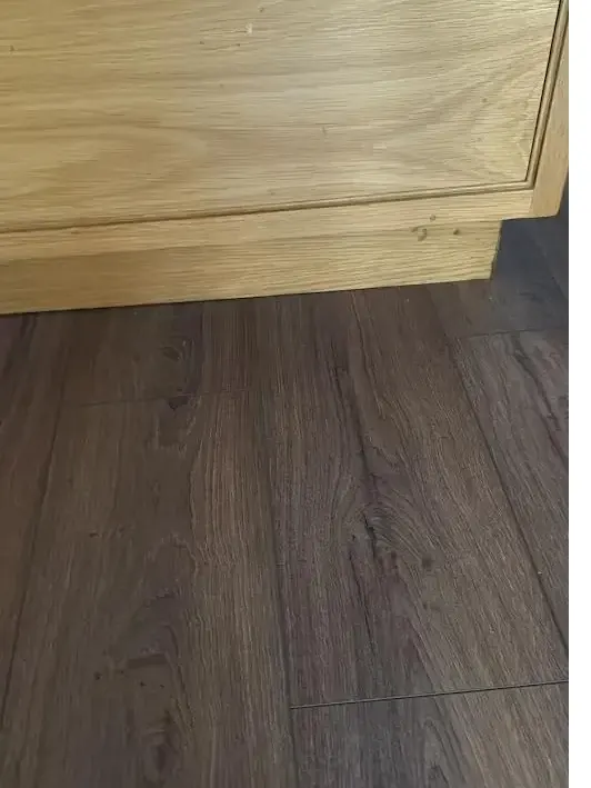 Light grey laminate flooring in a freshly finished room