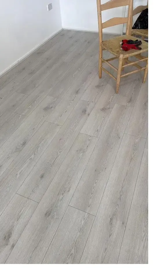Light oak laminate flooring fitted in a bright living room