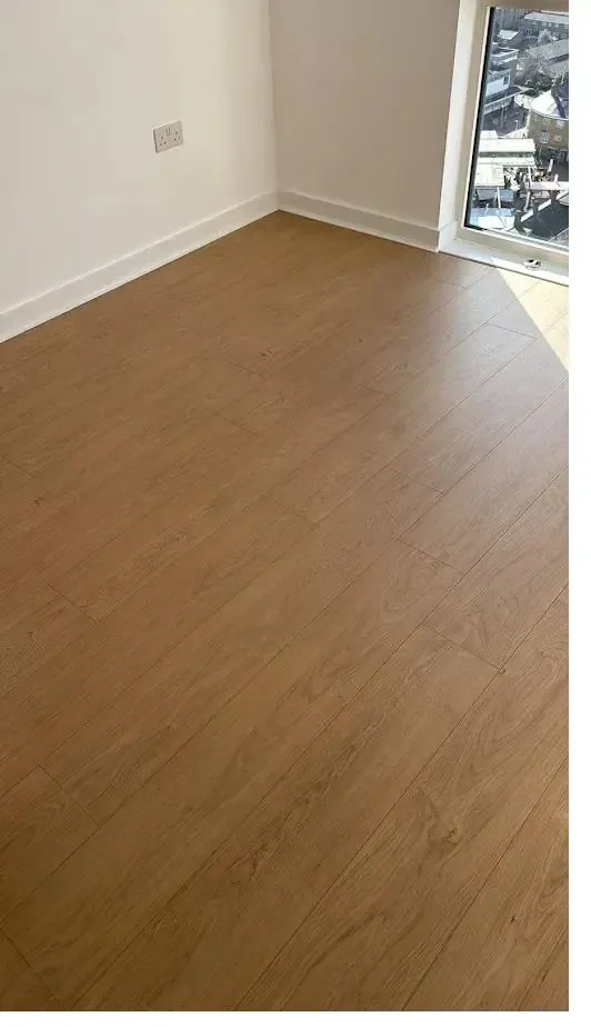 Warm oak laminate flooring in a sunlit room