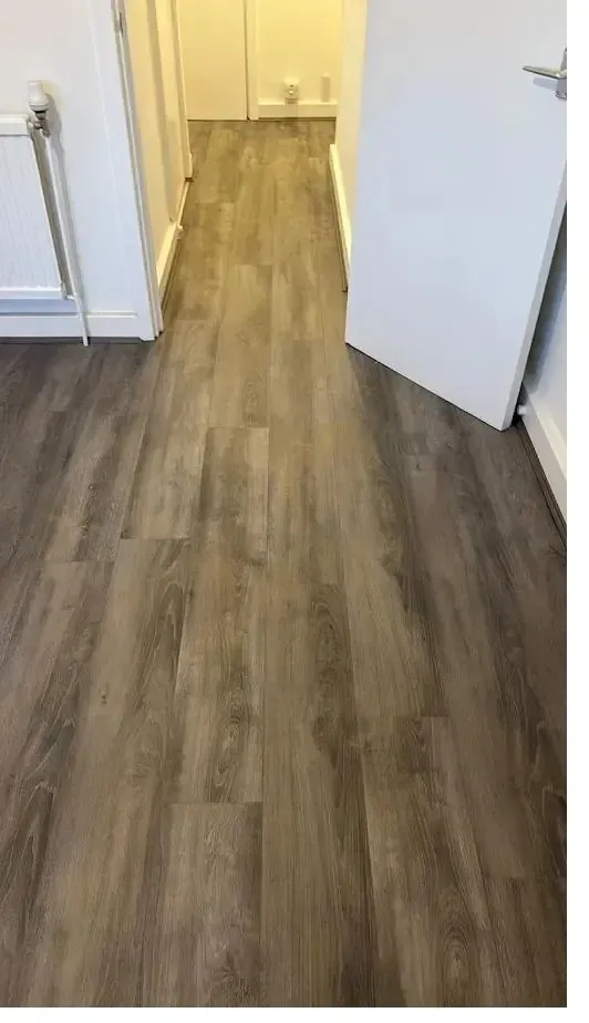 Taupe luxury vinyl tile flooring fitted in a hallway