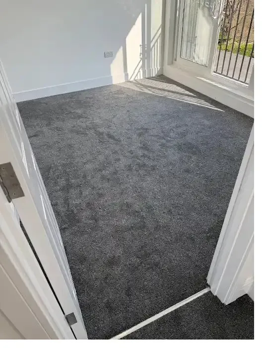 Dark grey carpet fitted on a bright landing