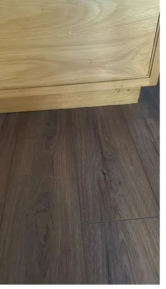 Light grey laminate flooring in a freshly finished room
