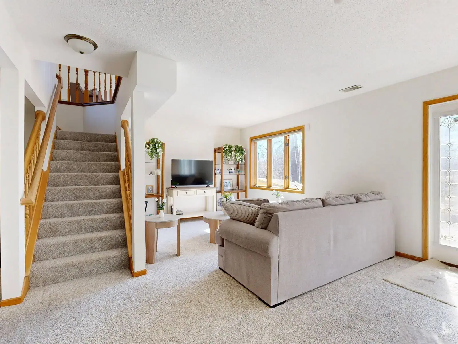 Light carpet in a living room and up the stairs