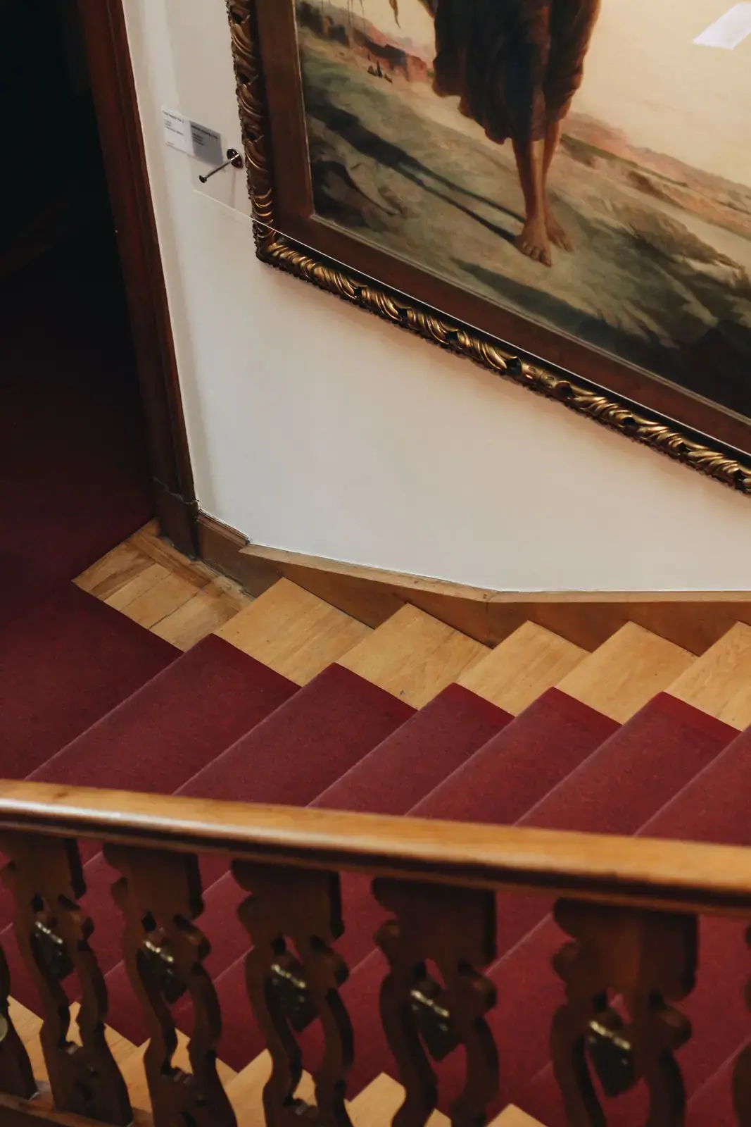 Red stair runner fitted on a timber staircase